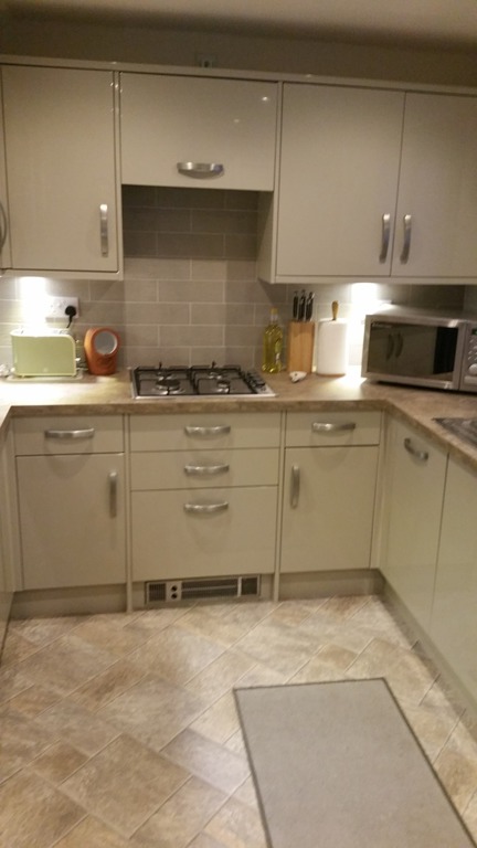 Completed cream shaker kitchen with tiled splashback and integrated appliances fitted by LMB Joinery.